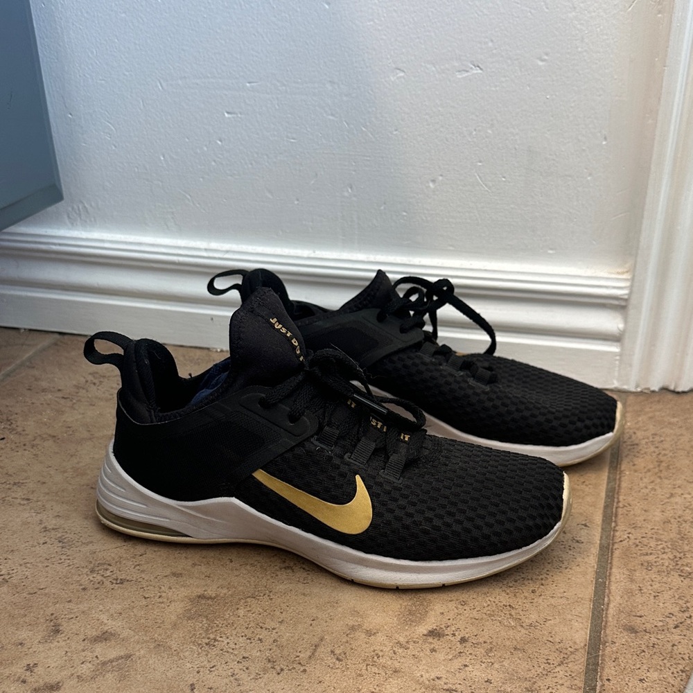 Nike Black Athletic Shoes with Gold Swoosh